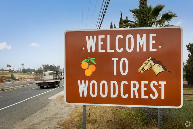 The Woodcrest welcome sign greets you to a hillside community with ranch homes in Woodcrest, CA.