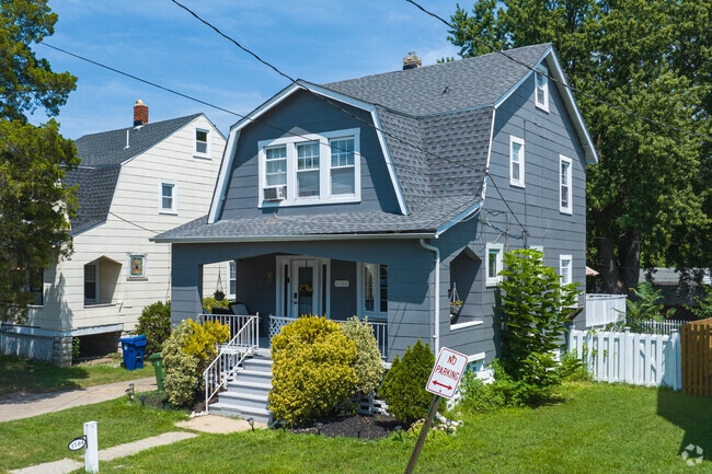 A well-manicured Dutch Colonial home with a large front porch in Waltherson.