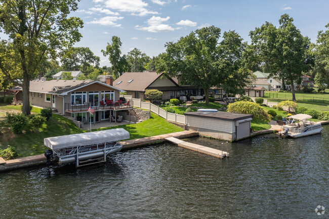 Riverview East homes with manicured lawns line the St. Joseph River.