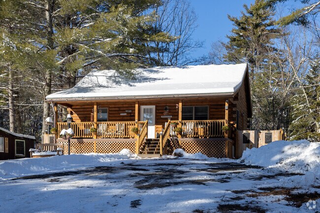 This charming small home in Brownfield, Maine, features a classic front porch, perfect for enjoying the peaceful, rural surroundings and community spirit.