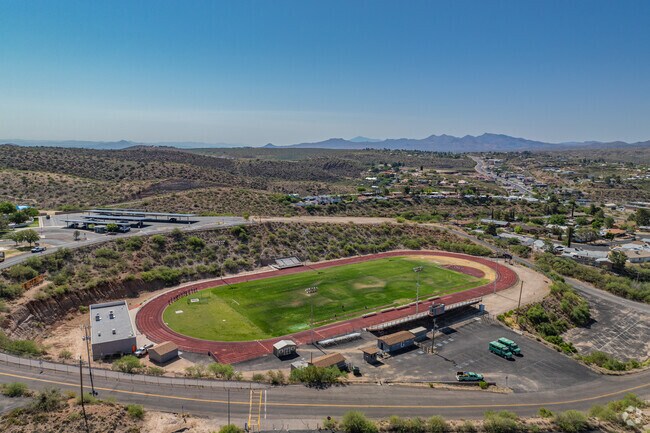 A red running track and field area gives students access to athletics and outdoor activities in the heart of campus.