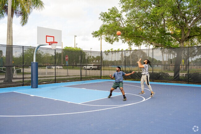 Enjoying a quick basketball game with friends at the Cypress Hammock Park near Cypress Run.