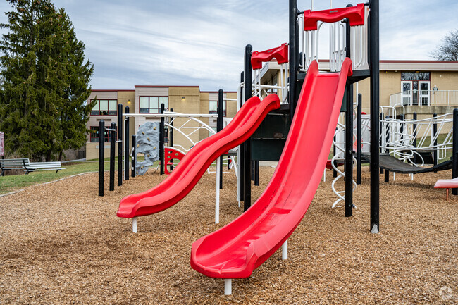 Students can have a race down the dual slides in the play yard at Baker Elementary School.