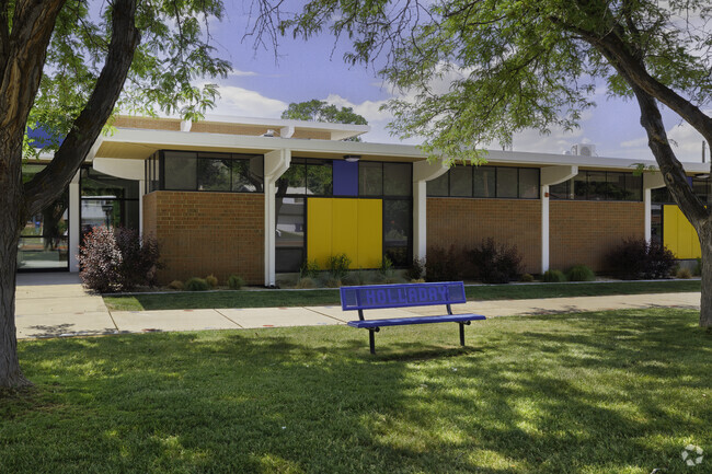 A blue bench at the entrance of Howard Driggs Elementary School.