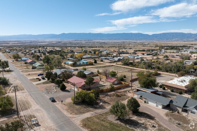 The flat lands of Penrose are dotted with shrubs and small trees throughout.