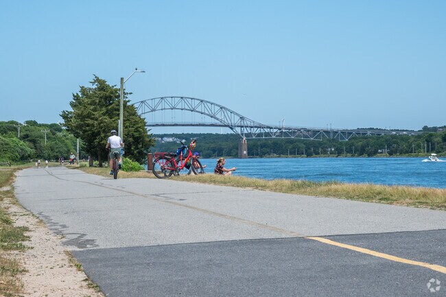 Cyclists can rest along the 14-mile Cape Cod Canal Bikeway and watch the boats pass by.