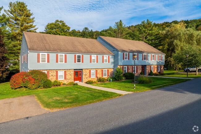 A colonial style condominium complex in Northfield Street has red shutters