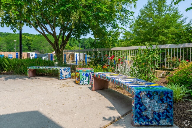 Mosaic decorated benches adorning the front entrance of Albert Einstein Academy.