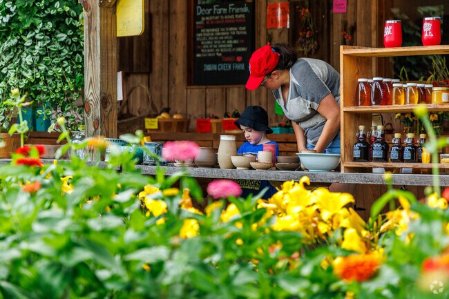 Residents of West Hill come to Indian Creek Farm to buy fresh produce and pick berries.