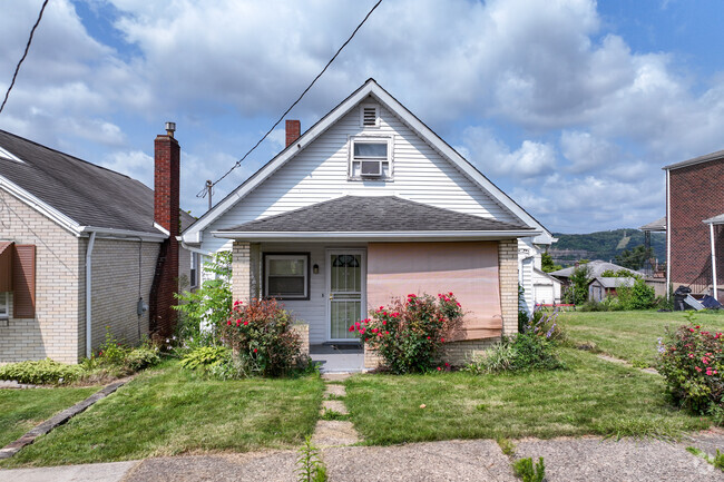 A cozy cottage with beautiful flowers in the front yard, located in Arnold.