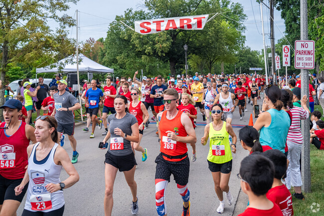 Energetic runners kick off the 19th year of the 4 On The 4th race in Elmhurst, IL.