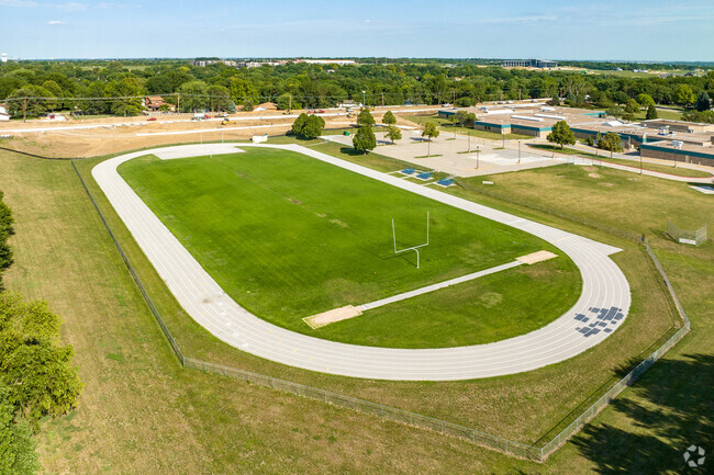 Behind the school is a full-size track and football field for athletics and PE.