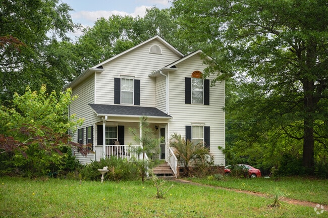 A white 2 story home with a small balcony in Whitney.