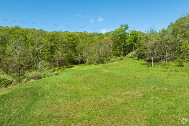 High Rock Farm Preserve invites residents of Lippitt Estates to explore scenic trails and enjoy the tranquility of preserved open space.