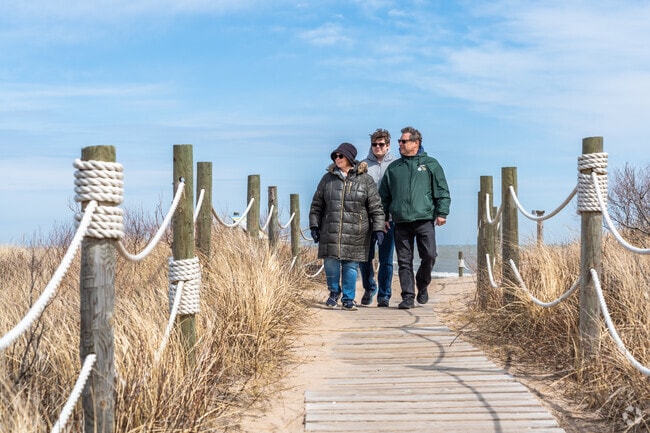 A family enjoys walking the boardwalks and dunes at North Beach Park.