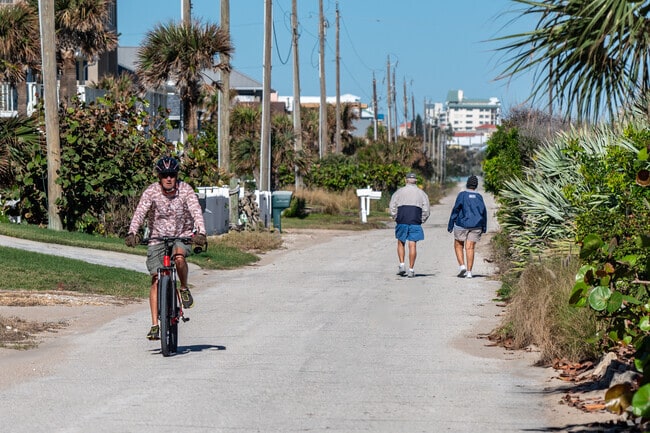 Bethune Beach residents walk along the coast along A1A.
