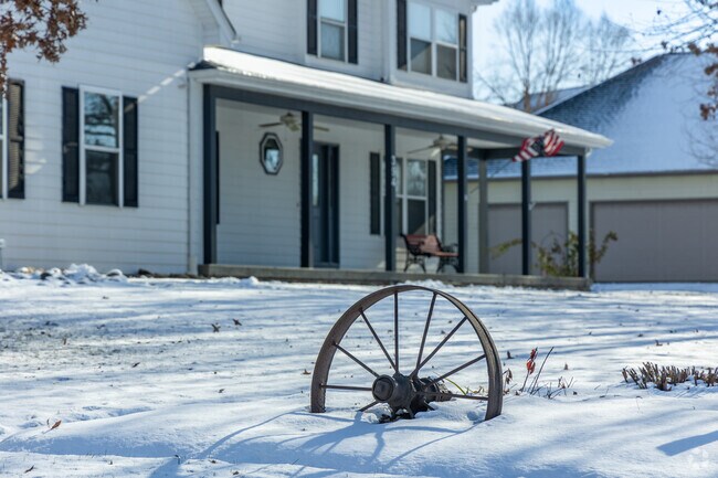 A unique, antique wagon wheel sits near a home in downtown Burlington.