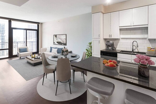 Nic on 5th Apartments in Minneapolis, Minnesota- Large furnished kitchen and living room with wooden floors and tall windows