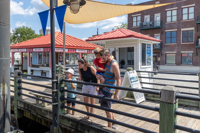 Families look for gators near the water near Princess Place.