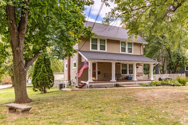 A stone bench sits beneath a tree at an Ott-Chrisman home.
