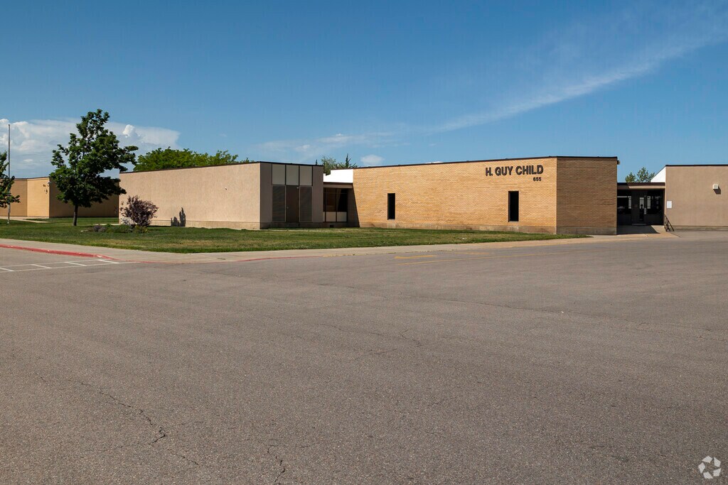 Modest earth tone buildings comprise H Guy Child Elementary School in Washington Terrace.