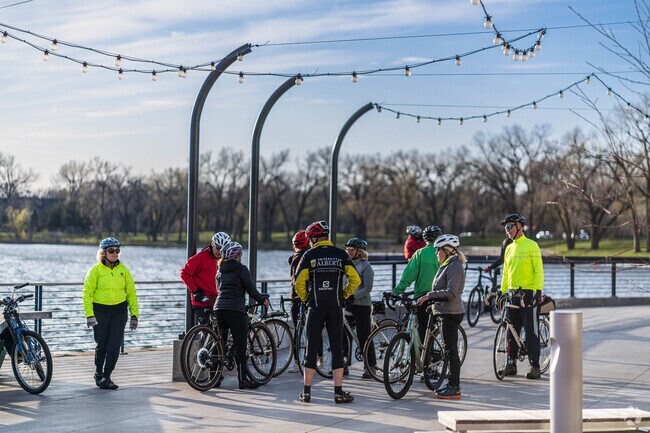 A group of cyclists meet up for a ride at Bde Maka Ska