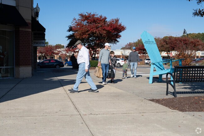 Shoppers explore Queenstown Premium Outlets for top brands and deals.