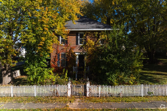 Older brick houses in Kingston are often shaded by trees.