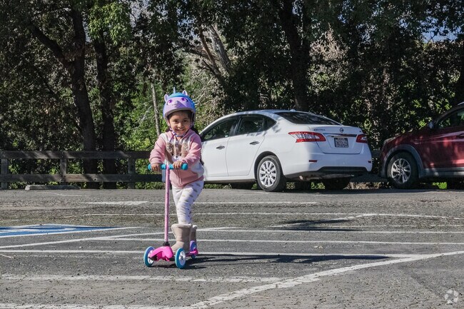 Young adventurer Girl scooting around Buchanan Park, Meadowbrook.
