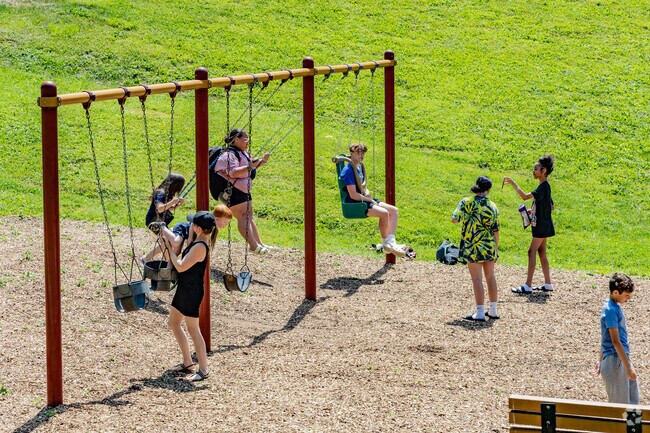 Friends and family play on the swings at Canonsburg Township Park.