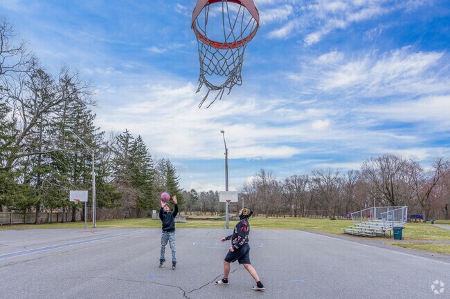 A couple of folks enjoying the weather shoot hoops at Szot Park near Chicopee Center.