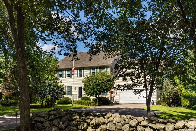 The classic Colonial enjoy privacy within the dense forest surrounding Bozrah.