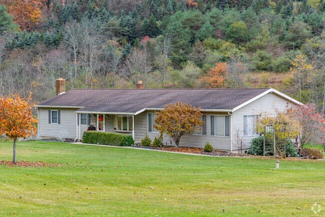 A secluded ranch home is tucked into the hillside in Redbank Township.