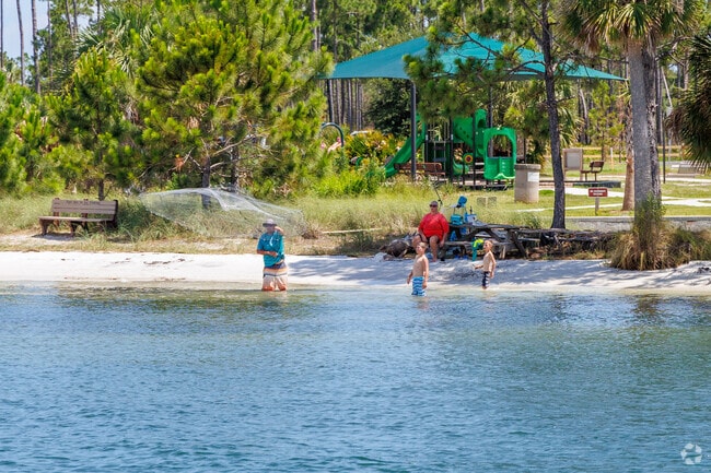 Families fish along the shore of St. Andrews State Park.