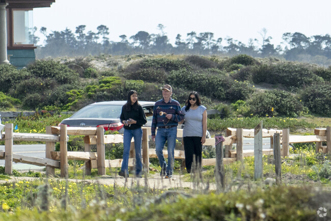 A family walking around in the Pacific Grove neighborhood.