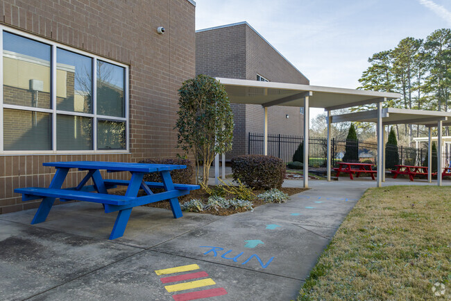 Covered walkways connecting buildings and outdoor student activity area at J. B. Page Elementary
