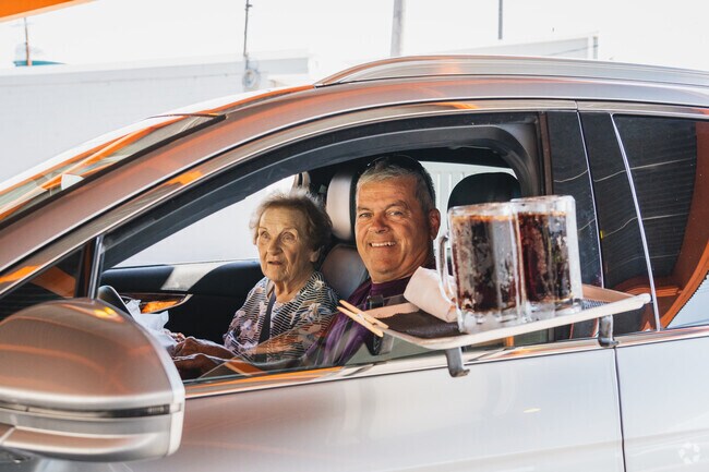 Another happy customer gets their root beers served in frosted mugs on a hot summer day.