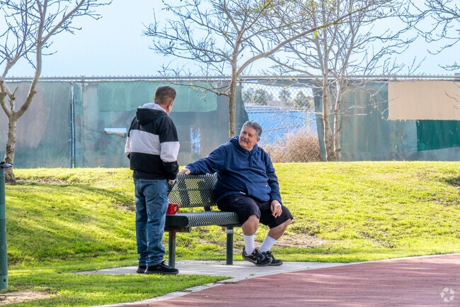 Locals enjoy catching up while on a walk through the East Village community of Oxnard.