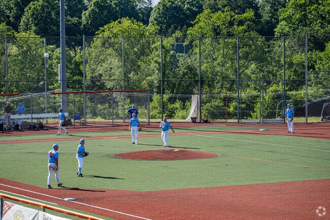 Baseball players warm up for a game at the field behind Greater Latrobe Junior High School.