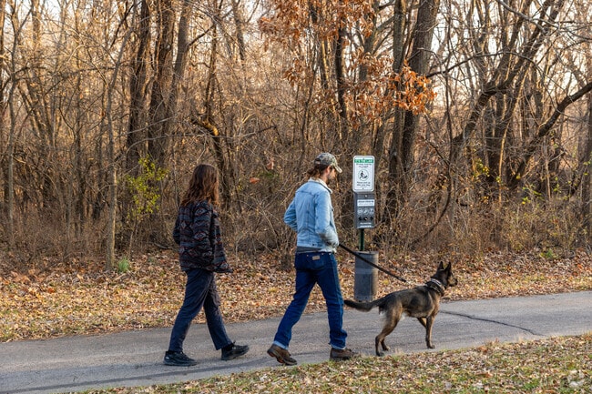 Locals walk the paved trails after work at Cross Creek Park.