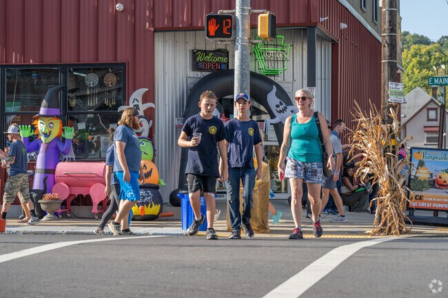 Residents enjoy the fall decor while walking through the Evans City Pumpkin Fest.