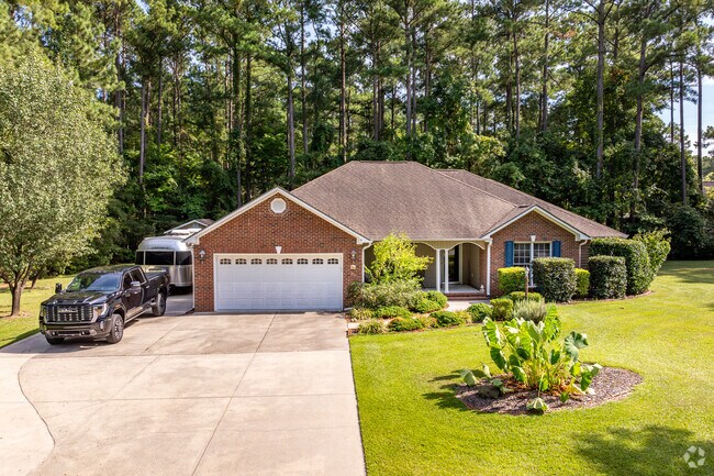 Older homes in Cherry Branch are nestled under the city of Havelock's mature trees.