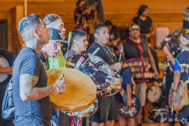 People dum and chant while others dance at the House of Awakened Culture in Suquamish.